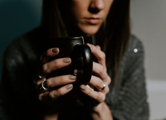 Sad woman drinking coffee